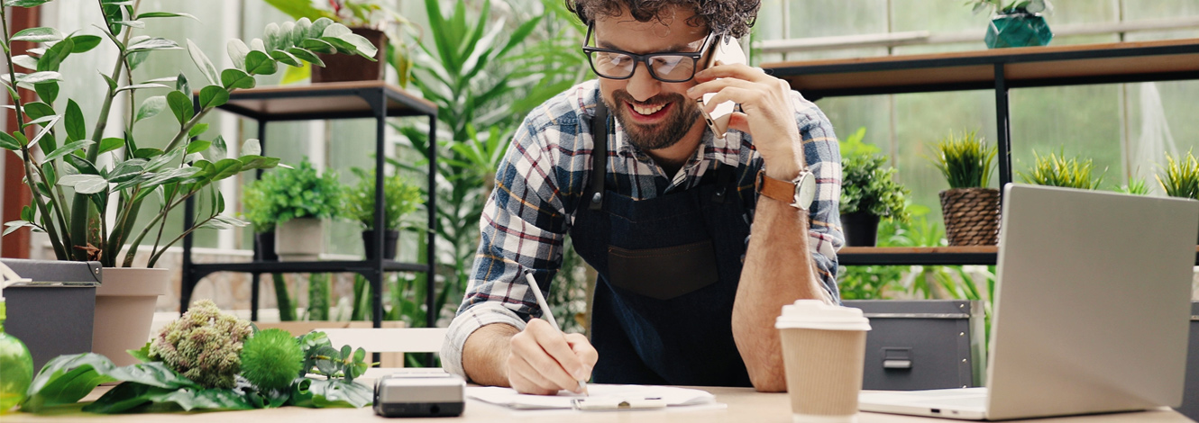 businessman talking on cellphone in store