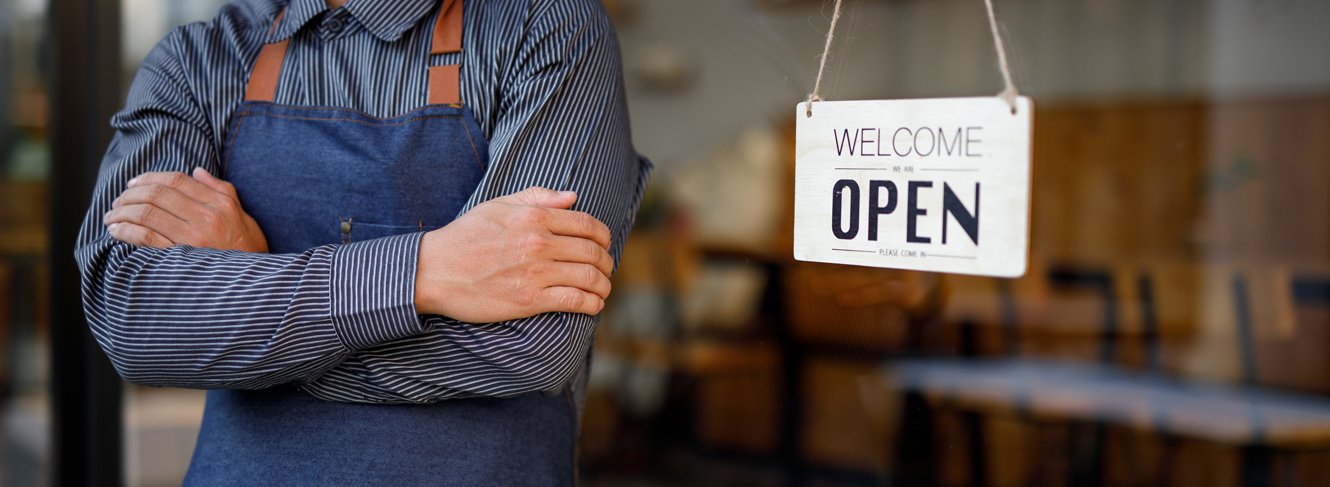 store owner turning open sign