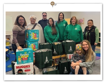 IFS employees gather with Elizabeth Gillander (Birth to Three Director) and Laura Ouellette & her daughter Anna who are clients of the Birth to Three Center.  