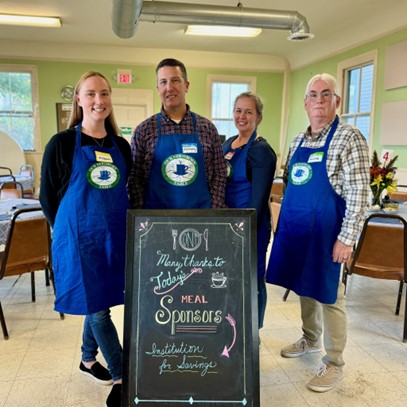 IFS employees serving dinner at Our Neighbors' Table in 2024